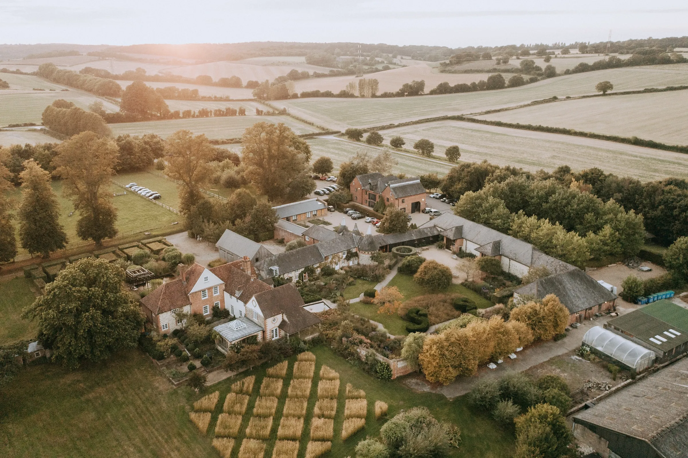 The Bury Court estate from the air, with its gardens, barns and farmland beyond